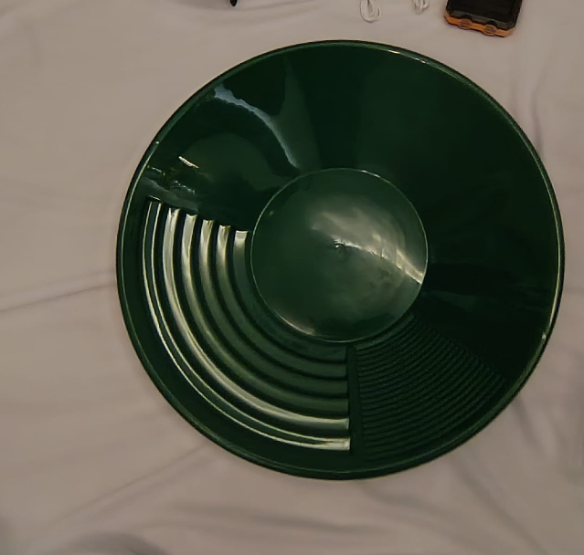 The ribbed green gold-panning dish for washing gravel and separating fine gold